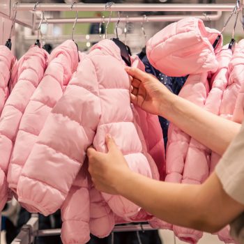 Warm children's jackets on hangers in a clothing store., the concept of shopping for clothes for children.